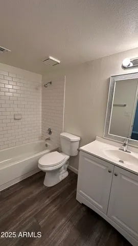 a bathroom with a toilet a sink and bathtub