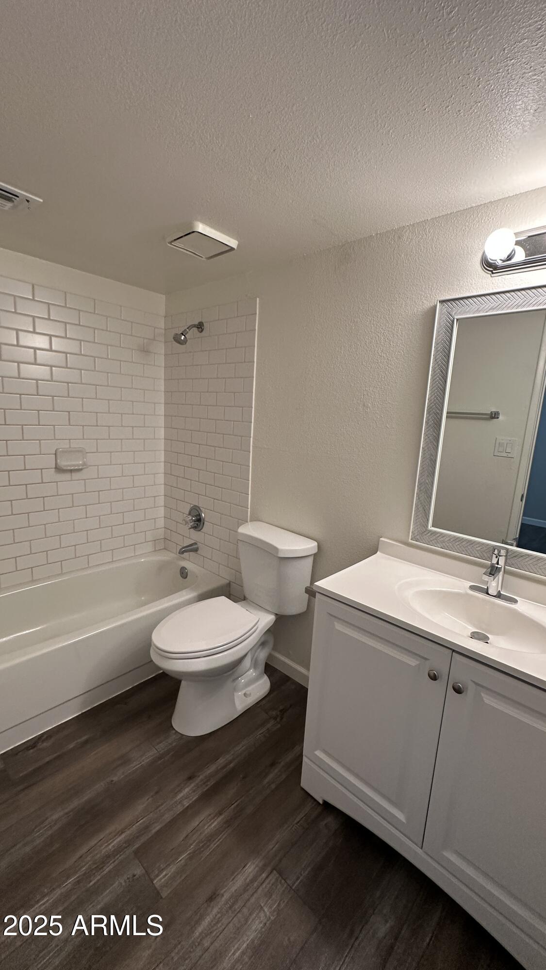 17847 North 40th Street, Unit 1 Phoenix, AZ 85032 - Photo 8 of 12 a bathroom with a toilet a sink and bathtub