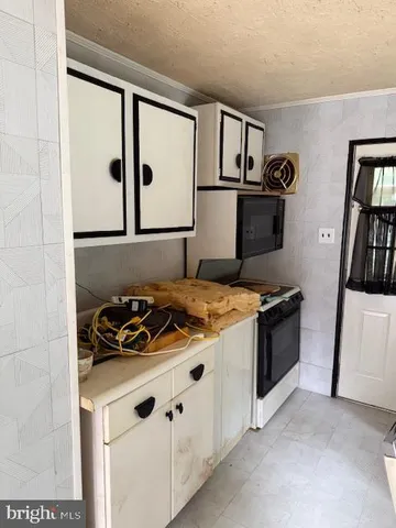 a kitchen with a stove and a refrigerator