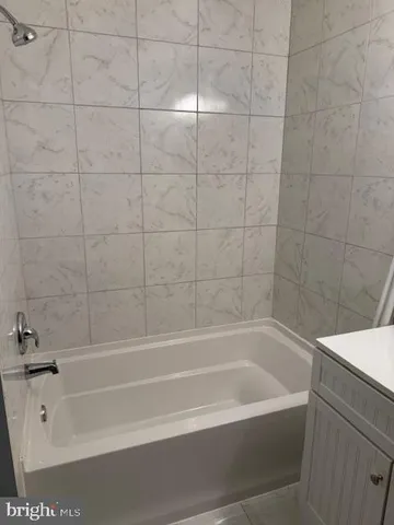 a bathroom with bathtub and shower