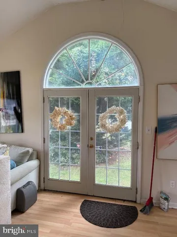 a living room with a large window and a rug