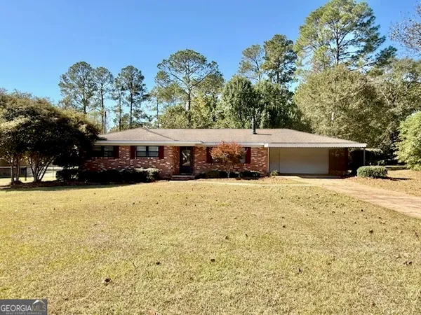 a front view of a building with trees