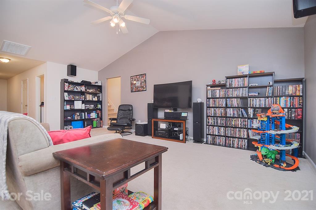 607 Hunley Street Monroe, NC 28112 - Photo 11 of 29 a living room with furniture a pool table and a flat screen tv