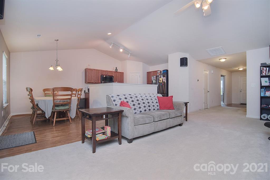 607 Hunley Street Monroe, NC 28112 - Photo 12 of 29 a living room with furniture and a chandelier