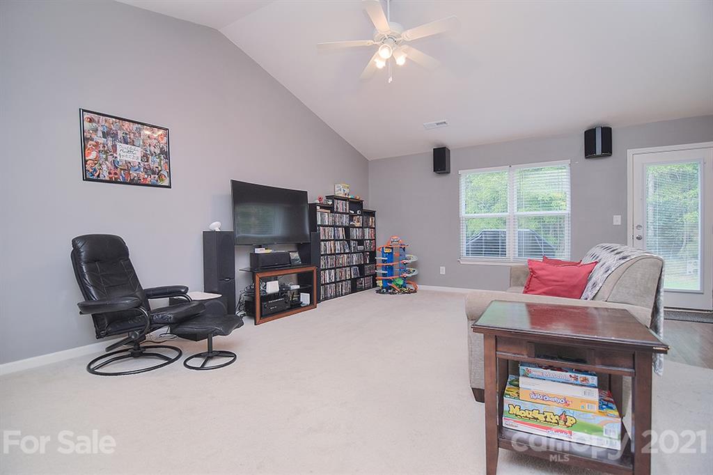 607 Hunley Street Monroe, NC 28112 - Photo 13 of 29 a living room with furniture a window and a flat screen tv