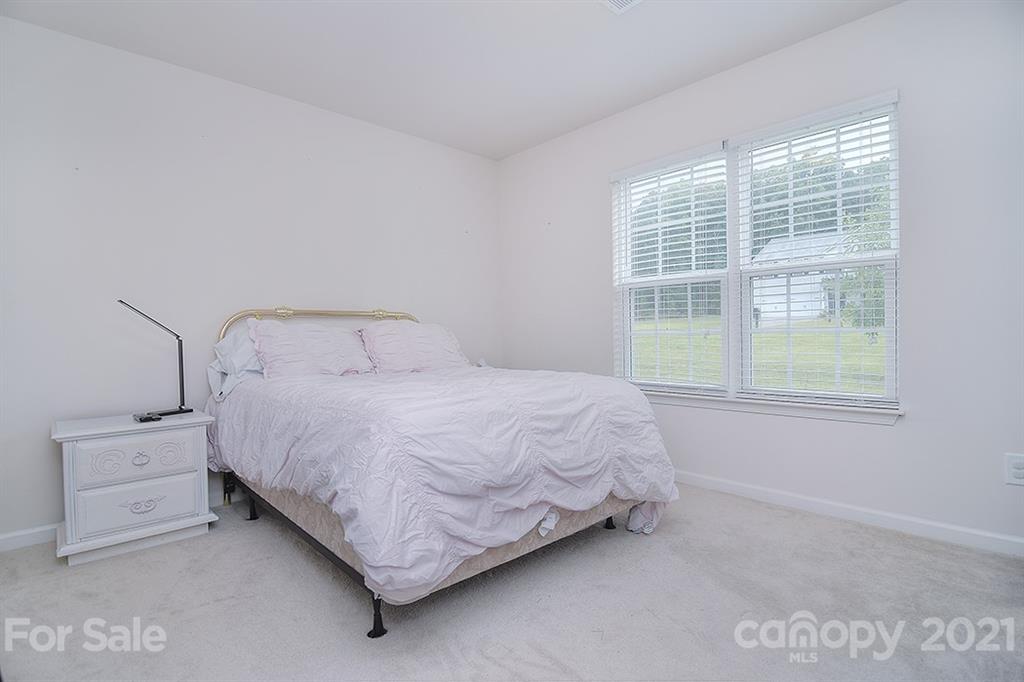 607 Hunley Street Monroe, NC 28112 - Photo 15 of 29 a bed sitting in a bedroom next to a window