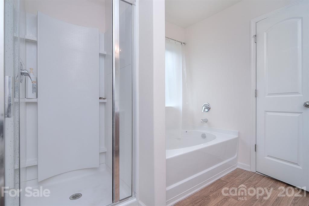 607 Hunley Street Monroe, NC 28112 - Photo 16 of 29 a bathroom with a bathtub and a shower