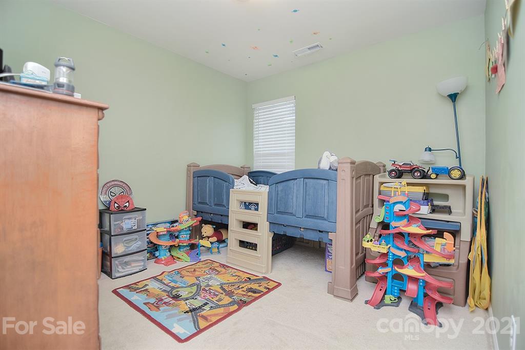 607 Hunley Street Monroe, NC 28112 - Photo 19 of 29 a room with toys and a baby crib