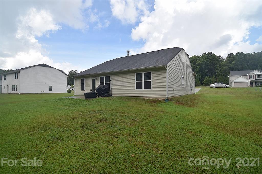 607 Hunley Street Monroe, NC 28112 - Photo 25 of 29 a view of a house with a backyard