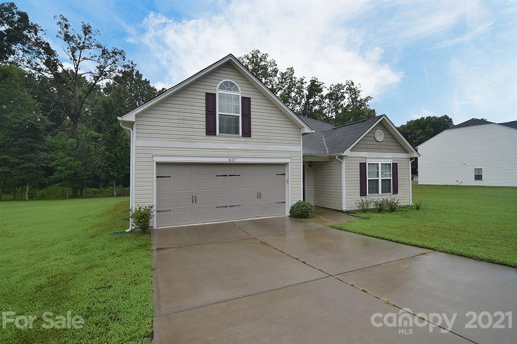 607 Hunley Street Monroe, NC 28112 - Photo 29 of 29 a front view of a house with a yard and garage