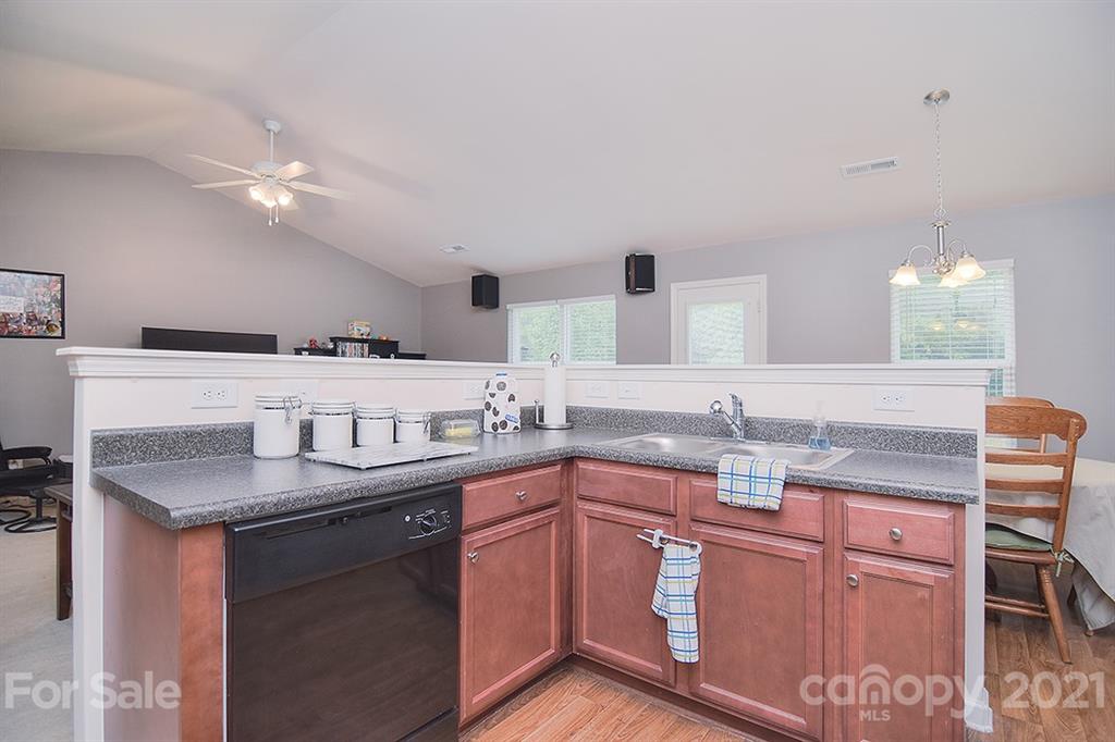 607 Hunley Street Monroe, NC 28112 - Photo 5 of 29 a kitchen with stainless steel appliances granite countertop a sink and dishwasher