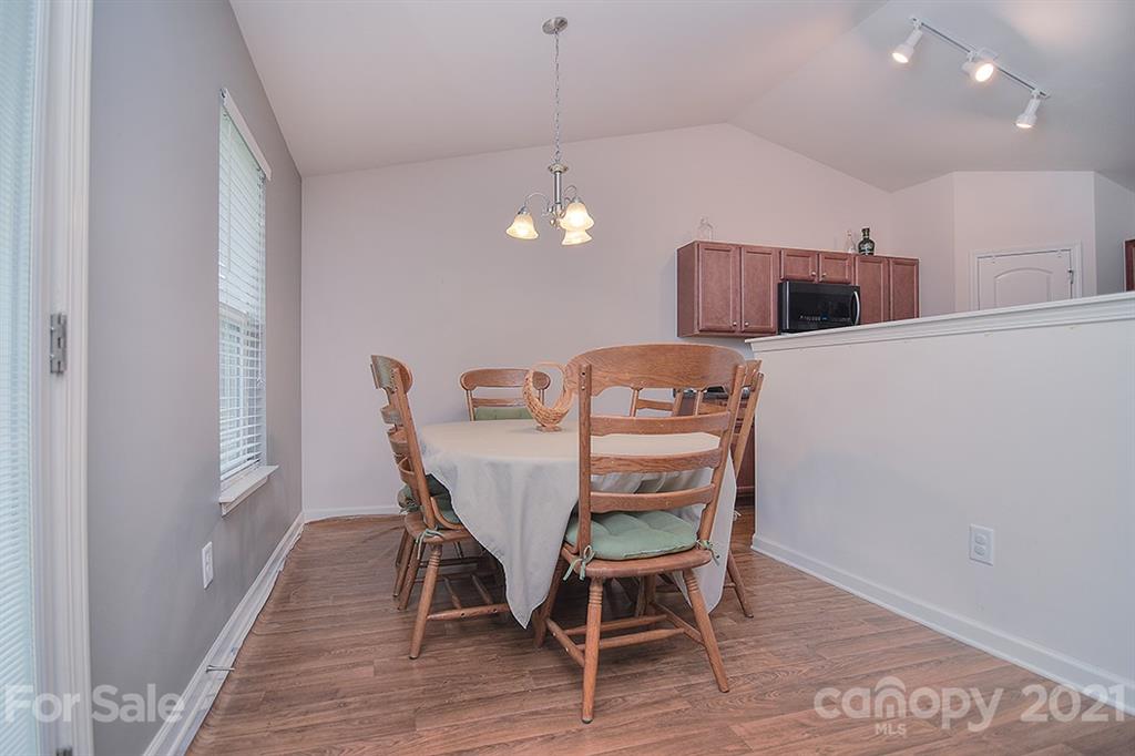 607 Hunley Street Monroe, NC 28112 - Photo 7 of 29 a view of a dining room with furniture and wooden floor
