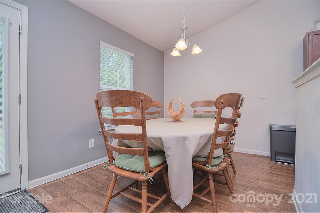 607 Hunley Street Monroe, NC 28112 - Photo 8 of 29 a view of a dining room with furniture and wooden floor