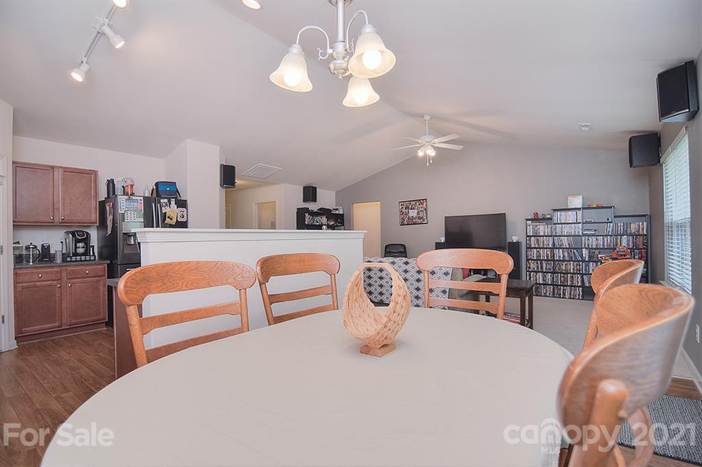 607 Hunley Street Monroe, NC 28112 - Photo 9 of 29 a bedroom with furniture and a chandelier