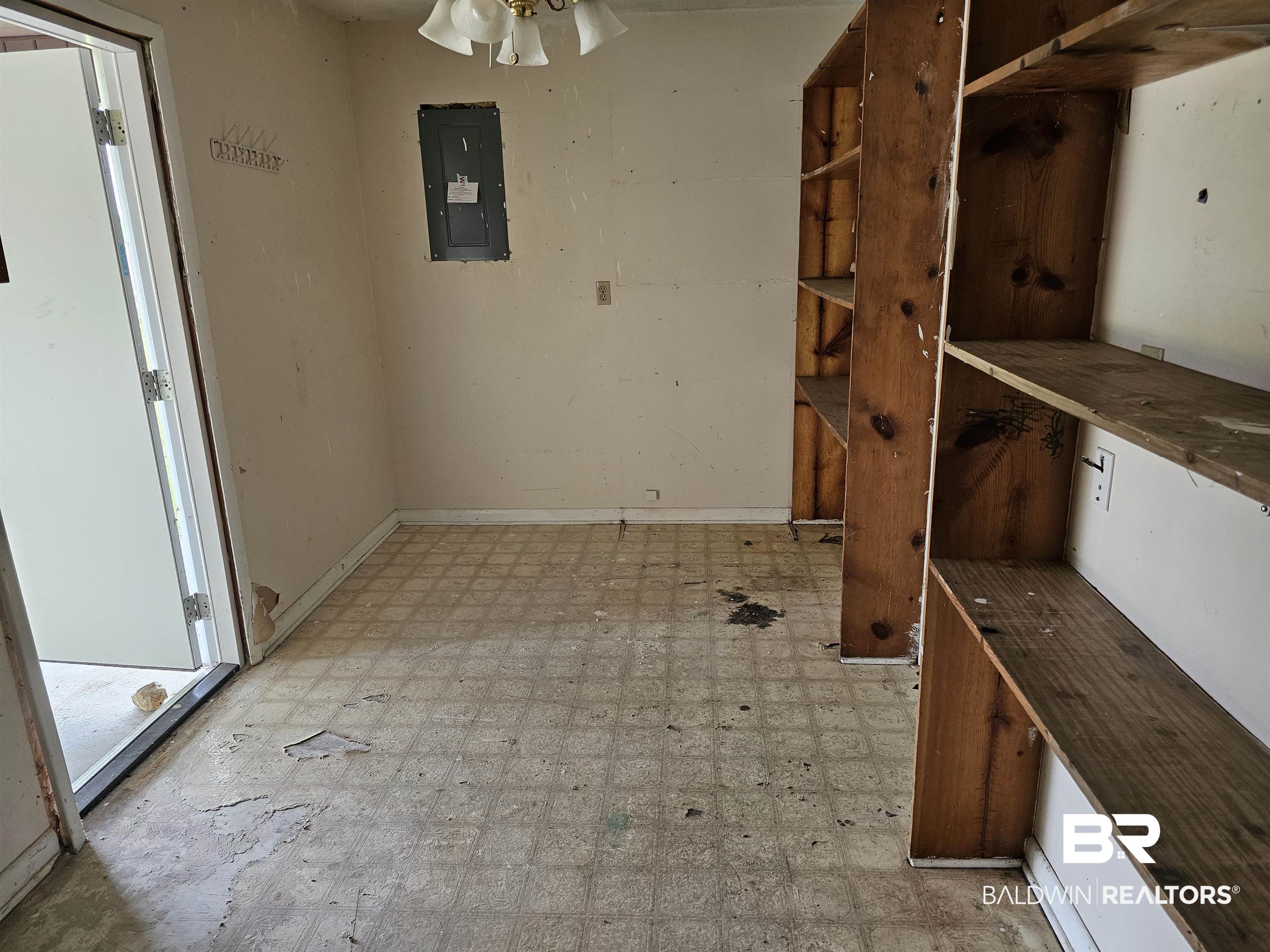 59575 Lottie Road Atmore, AL 36502 - Photo 14 of 23 Unfurnished dining area with electric panel, ceiling fan, light floors, and baseboards