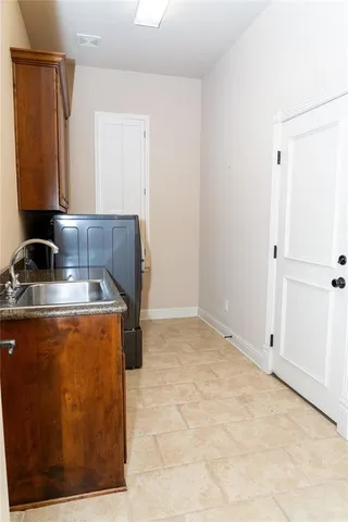 a room with a sink and a refrigerator