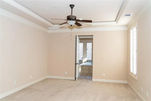 a view of empty room with ceiling fan