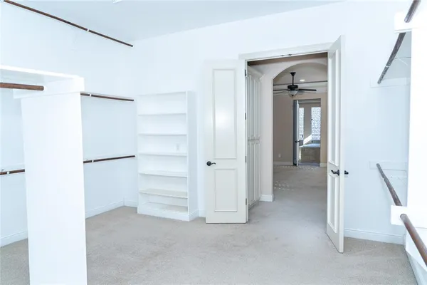 a view of an empty room with a ceiling fan