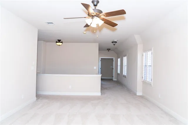 a dinning room with chandelier fan