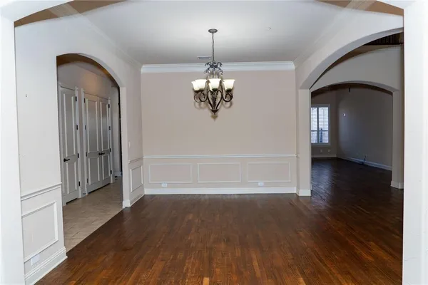 a view of a room with wooden floor staircase and a living room
