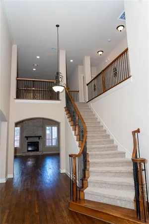 a view of entryway and hall with wooden floor
