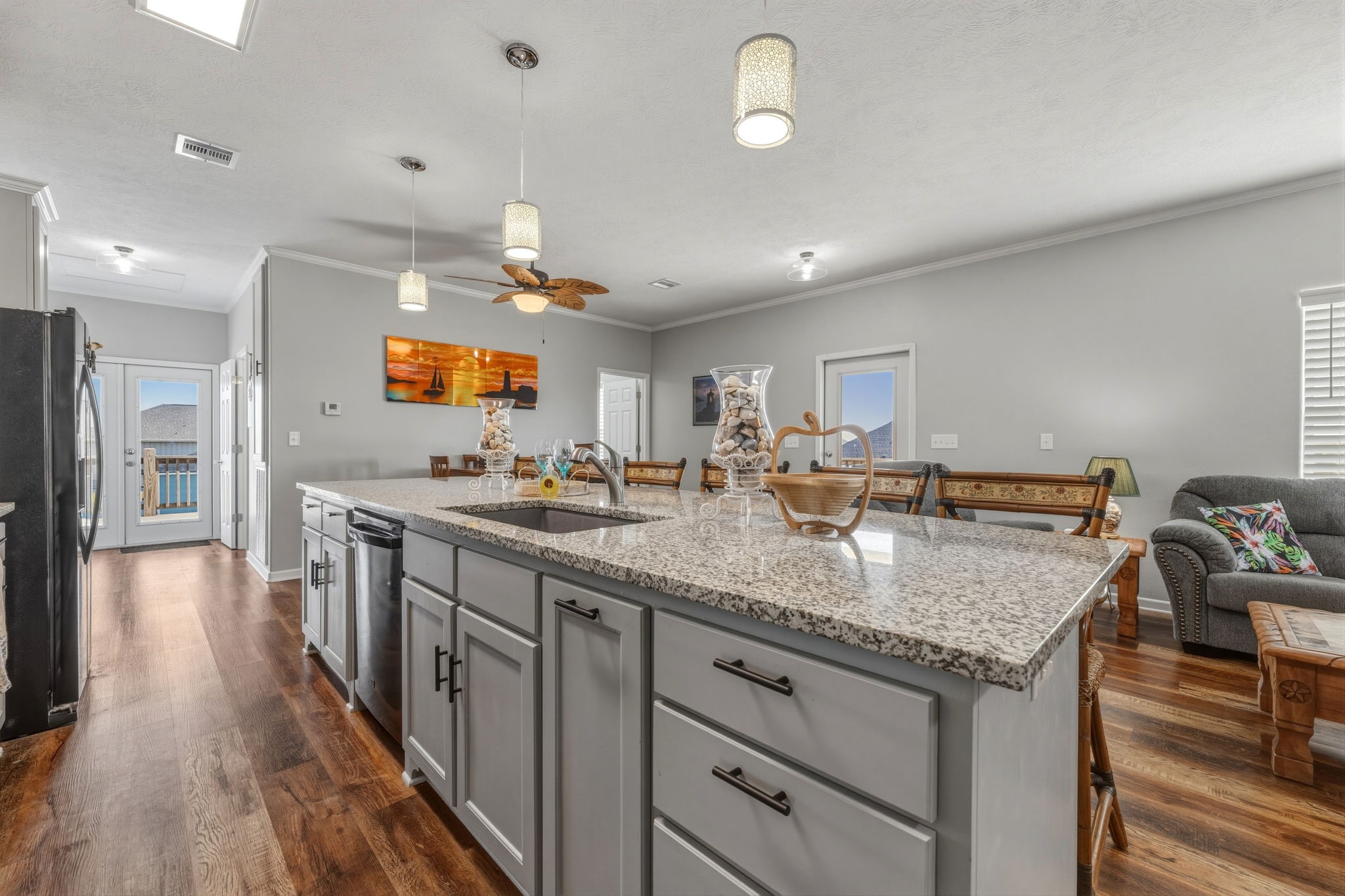 920 Palm View Crystal Beach, TX 77650 - Photo 15 of 26 a kitchen with stainless steel appliances granite countertop a lot of counter space and wooden floors