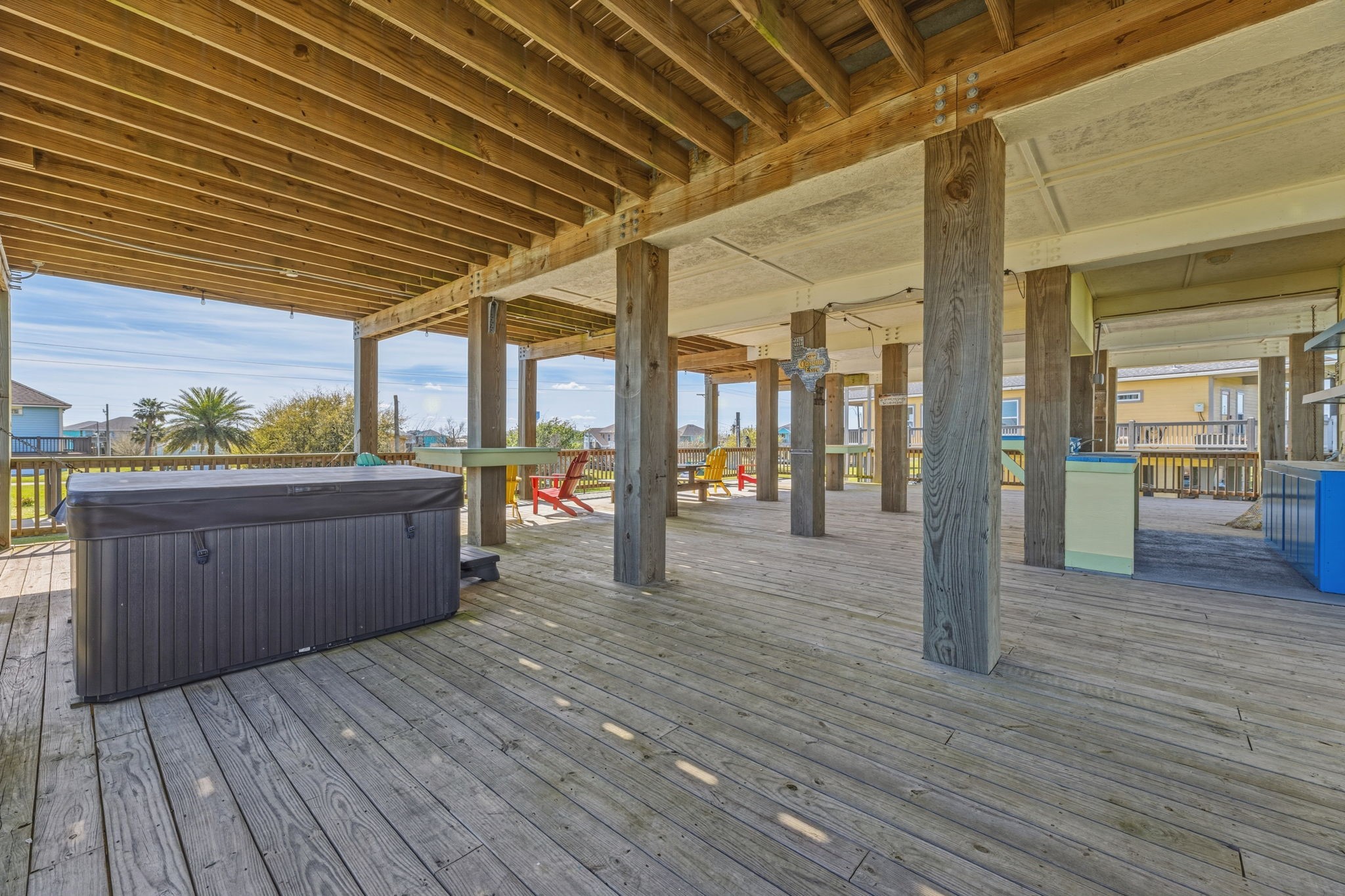 920 Palm View Crystal Beach, TX 77650 - Photo 7 of 26 a view of a porch with wooden floors and wooden walls
