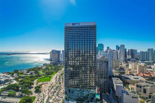 a view of balcony with two potted plants and wooden bench