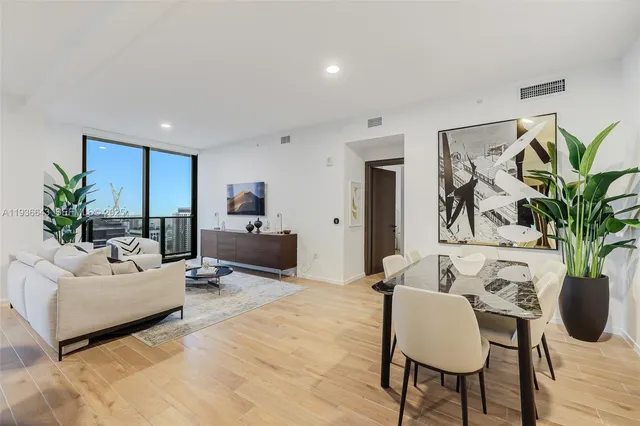 a view of a dining room with furniture and wooden floor
