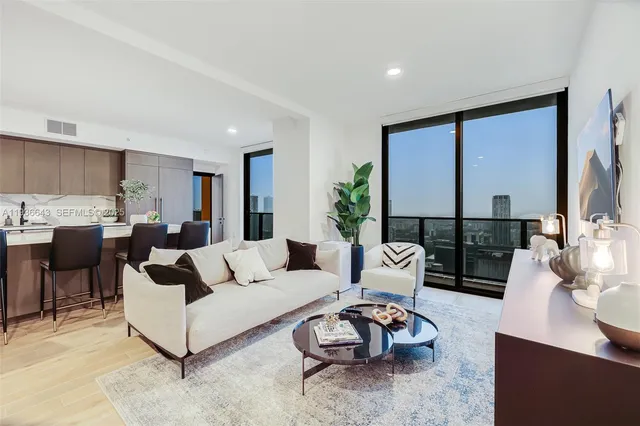 a living room with furniture rug and window