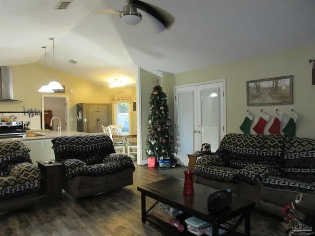 a kitchen with stainless steel appliances granite countertop a sink a stove and a refrigerator