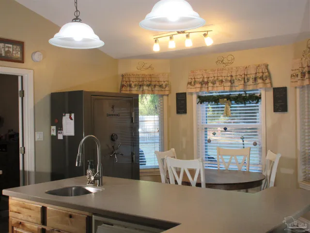 a kitchen with counter space dining table and chairs