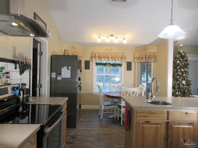 a kitchen with refrigerator and chandelier