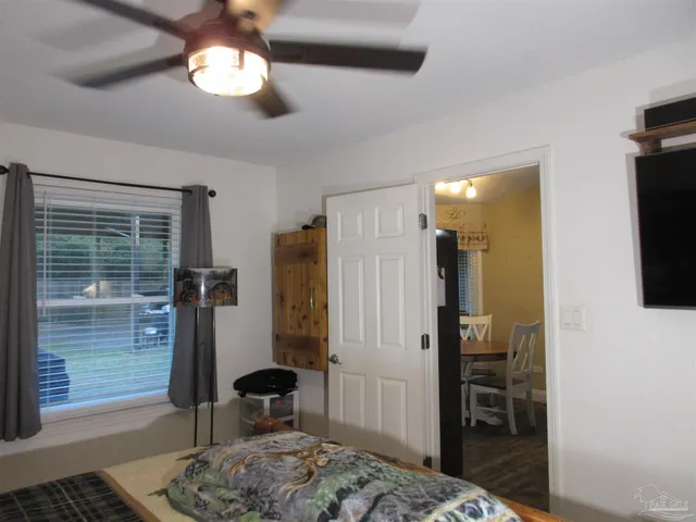 a bedroom with a bed and a painting on the wall