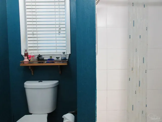 a bedroom with a bed and a flat screen tv in it