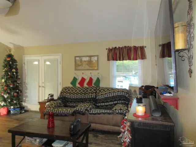 a view of a dining room with furniture and a chandelier
