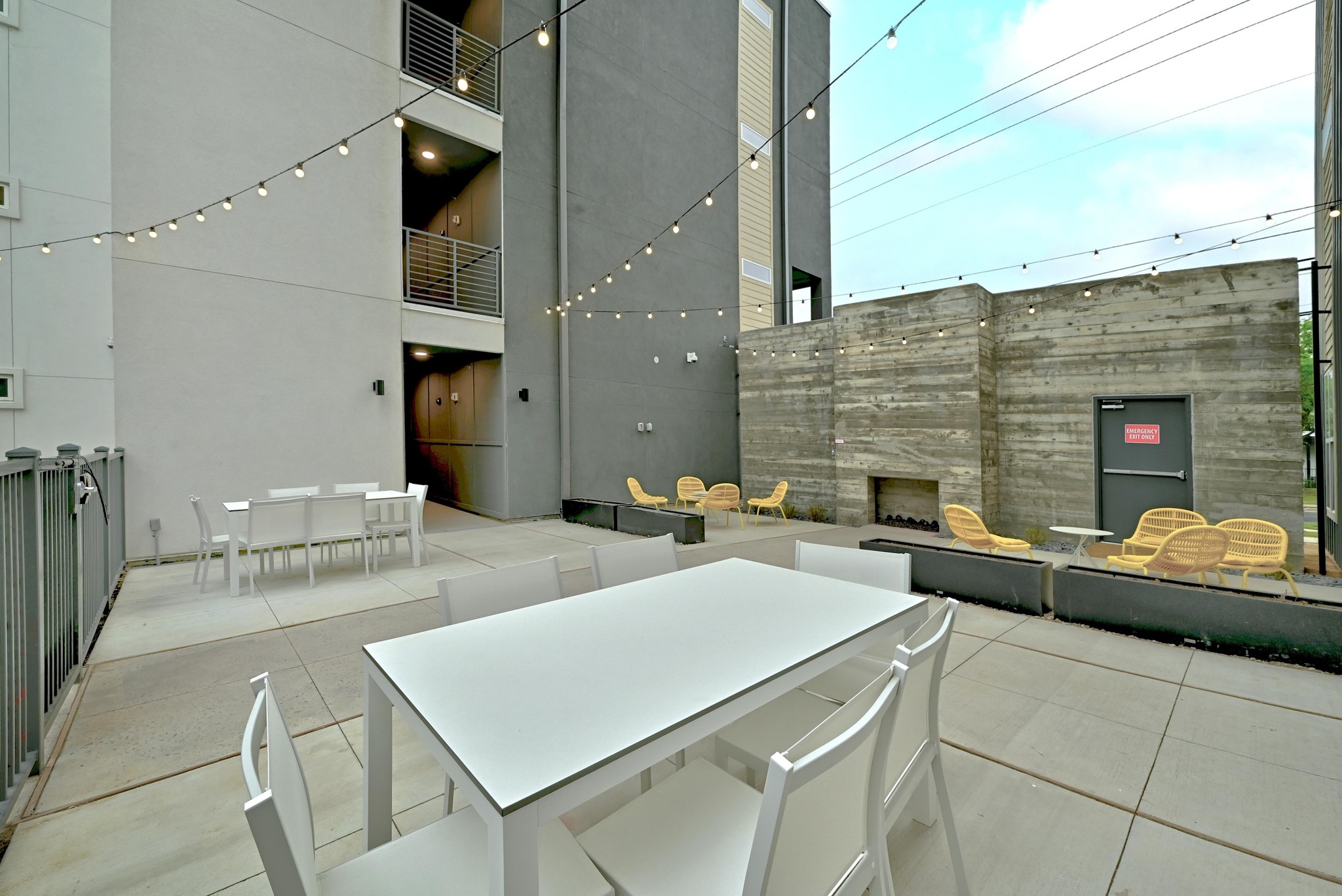 4801 Springdale Road, Unit 2301 Austin, TX 78723 - Photo 31 of 36 An inviting community patio space with strung lights and a modern outdoor fireplace provides a perfect setting for gatherings.