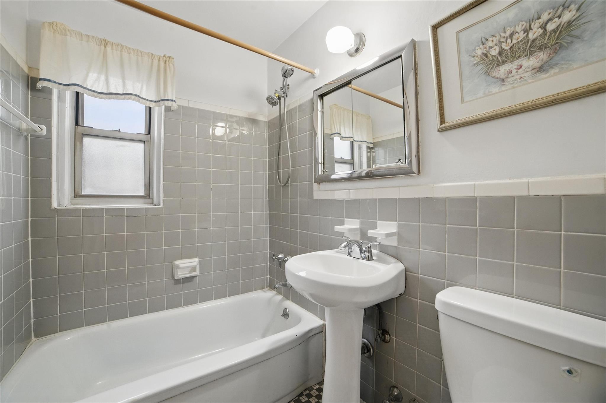 682 Tuckahoe Road, Unit 1A Yonkers, NY 10710 - Photo 12 of 17 a bathroom with a sink a toilet and shower