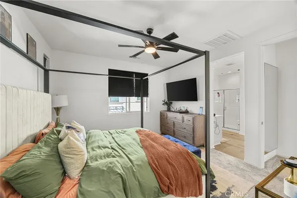 a bedroom with a flat screen tv and a bed