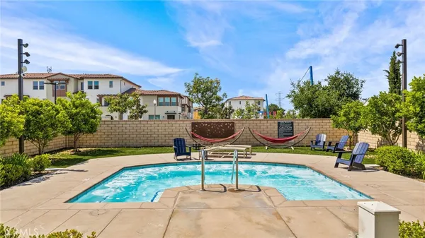 a swimming pool with outdoor seating and yard