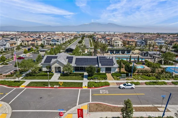 an aerial view of multiple houses with a swimming pool