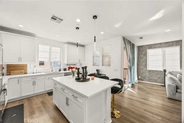 a view of a kitchen counter space wooden floor and a fireplace