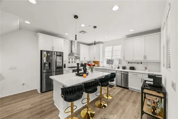 a kitchen with refrigerator cabinets dining table and chairs