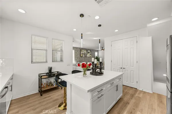 a view of a kitchen that has a sink a stove and a refrigerator