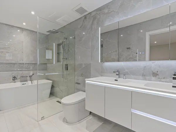 a bathroom with a double vanity sink mirror and toilet