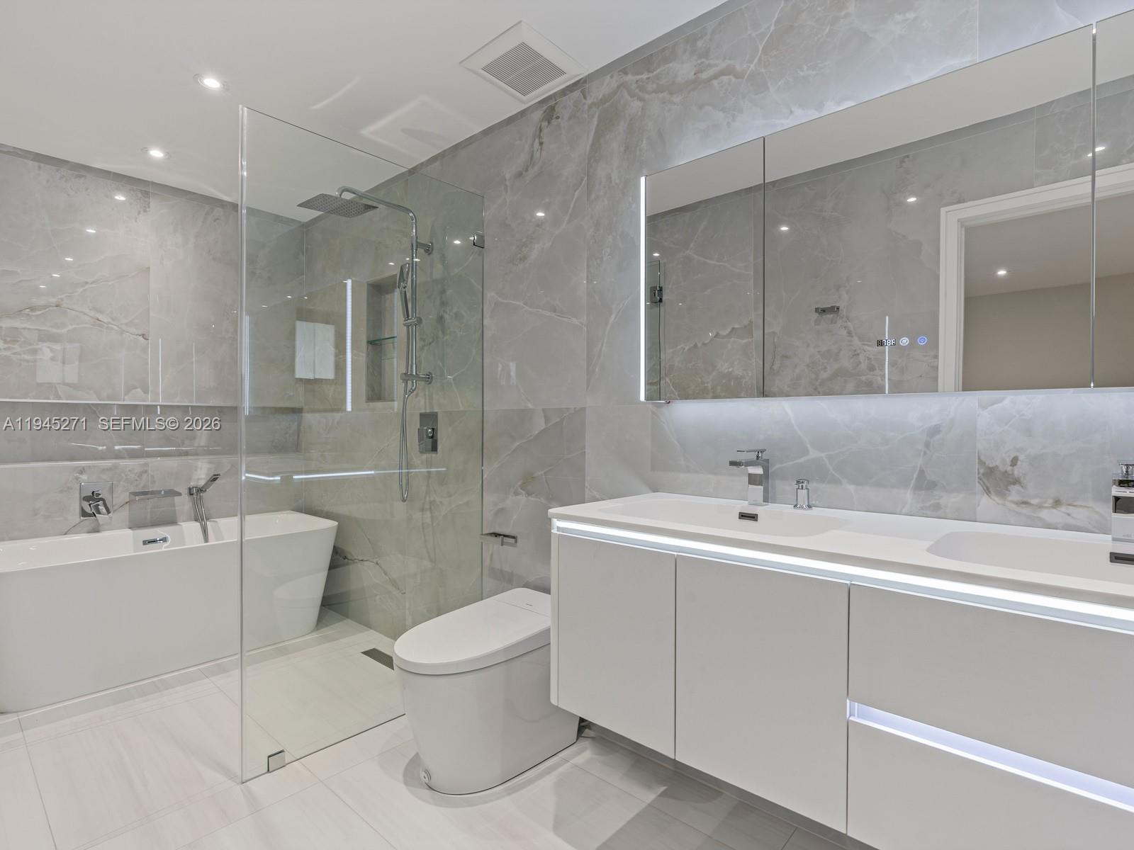 511 Southeast 14th Street, Unit 1 Pompano Beach, FL 33060 - Photo 13 of 20 a bathroom with a double vanity sink mirror and toilet