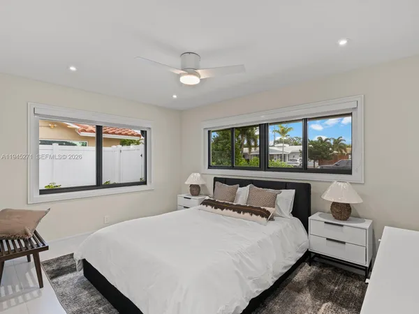 a bedroom with a large bed and a window