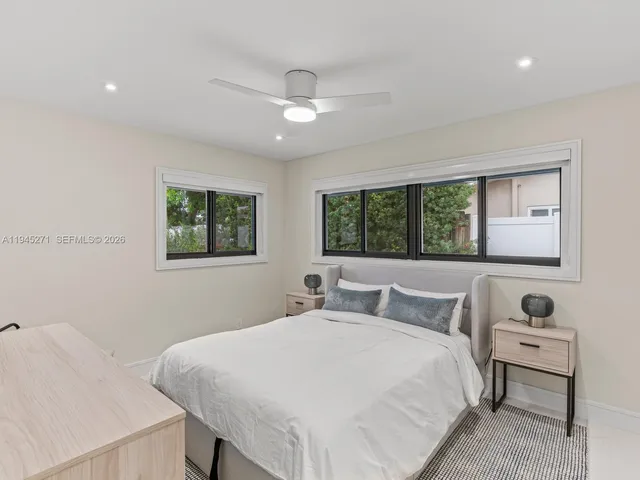 a bedroom with a large bed and a window