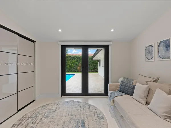 a large bedroom with a bed and a window