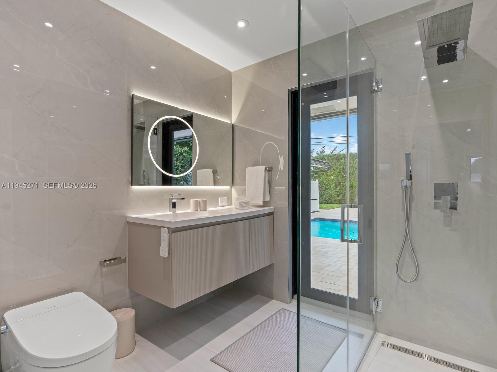 511 Southeast 14th Street, Unit 1 Pompano Beach, FL 33060 - Photo 18 of 20 a bathroom with a sink a toilet and shower